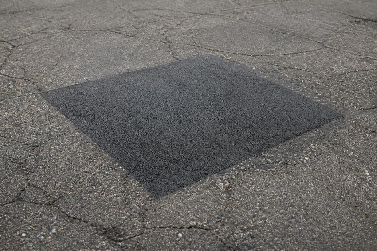Seamless asphalt patch blended into existing pavement